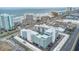 An aerial view shows the proximity to the coastline, roads, and surrounding community features at 2727 N Atlantic Ave # 2020, Daytona Beach, FL 32118