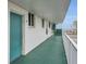 Bright condo hallway view with green carpet, a blue door, and ocean views at 2727 N Atlantic Ave # 2020, Daytona Beach, FL 32118