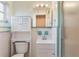 Clean bathroom featuring mint-green tile accents, a large mirror, and a shower with glass doors at 29 Jasmine Dr, Debary, FL 32713