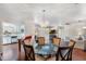 Spacious dining room with a modern chandelier, glass table, and easy access to the kitchen at 29 Jasmine Dr, Debary, FL 32713