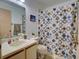 Cozy bathroom featuring a patterned shower curtain and neutral-toned fixtures at 2956 S S Semoran Blvd # 1407, Orlando, FL 32822