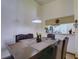 Dining room with dark wood furniture, a pendant light, and passthrough to the kitchen at 2956 S S Semoran Blvd # 1407, Orlando, FL 32822