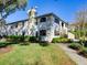 Well-maintained townhome exterior featuring lush landscaping and a welcoming facade at 2956 S S Semoran Blvd # 1407, Orlando, FL 32822