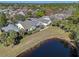 Aerial view of the homes backing onto the pond surrounded by trees and tropical vegetation at 300 Stonington Way, Deland, FL 32724