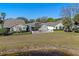 Beautiful view of well-maintained homes, pond, and backyard landscaping at 300 Stonington Way, Deland, FL 32724