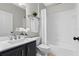 Bathroom featuring a shower-tub combo, white tile surround and a modern vanity at 300 Stonington Way, Deland, FL 32724