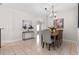 Dining area features decorative chandelier and tropical artwork at 300 Stonington Way, Deland, FL 32724