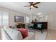 Bright open living room with modern decor, ceiling fan, and easy access to the kitchen at 300 Stonington Way, Deland, FL 32724