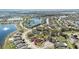 Aerial view of a suburban neighborhood featuring single-Gathering homes with fenced yards, mature trees, and a pond at 3223 Queen Alexandria Dr, Kissimmee, FL 34744