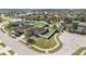 Aerial view of a single Gathering home with a fenced yard, playground, and well-manicured landscaping in a suburban neighborhood at 3223 Queen Alexandria Dr, Kissimmee, FL 34744