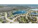 Aerial view of a suburban neighborhood featuring single-Gathering homes surrounding a scenic lake with a fountain at 3223 Queen Alexandria Dr, Kissimmee, FL 34744