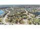 Aerial view of a suburban neighborhood featuring single-Gathering homes, fenced yards, mature trees, and a pond at 3223 Queen Alexandria Dr, Kissimmee, FL 34744