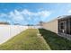 Large backyard surrounded by a privacy fence and green grass at 3223 Queen Alexandria Dr, Kissimmee, FL 34744