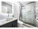 Elegant bathroom boasts marble walls, a sleek glass shower, and a modern vessel sink at 3223 Queen Alexandria Dr, Kissimmee, FL 34744