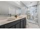 Modern bathroom featuring double vanity and walk-in shower with marble-look tile and decorative niche at 3223 Queen Alexandria Dr, Kissimmee, FL 34744