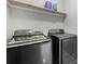 Close-up of modern front-loading Samsung washer and dryer set in a gray-toned laundry room at 3223 Queen Alexandria Dr, Kissimmee, FL 34744