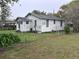 Exterior view shows home siding, windows, chainlink fence, and lush yard at 3420 Avenue R Nw, Winter Haven, FL 33881