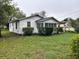 Exterior view shows home siding, windows and lush yard at 3420 Avenue R Nw, Winter Haven, FL 33881