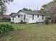 Exterior rear view of a one-story home with a chain link fenced yard at 3420 Avenue R Nw, Winter Haven, FL 33881