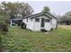 Exterior view of a house with a carport on a corner lot surrounded by a grassy yard at 3420 Avenue R Nw, Winter Haven, FL 33881