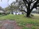 Home exterior with an large tree and a green front yard at 3420 Avenue R Nw, Winter Haven, FL 33881