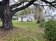 Home exterior with an large tree and a green front yard at 3420 Avenue R Nw, Winter Haven, FL 33881