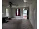 View of the spacious living room with carpet, ceiling fan, and natural light through the windows at 3420 Avenue R Nw, Winter Haven, FL 33881