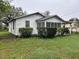 Exterior side view of a one-story home with a small landscaped yard at 3420 Avenue R Nw, Winter Haven, FL 33881