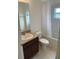 This bathroom includes a vanity with sink, a toilet, and a shower-tub combo with window at 424 Crabtree Ave, Orlando, FL 32835