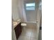 Well-lit bathroom features a shower-tub combo with tiled surround, toilet, and vanity with sink at 424 Crabtree Ave, Orlando, FL 32835