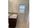 Bathroom featuring tile floors, a vanity, and a window for natural light at 424 Crabtree Ave, Orlando, FL 32835