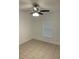 This bedroom is bright, has tile flooring, a ceiling fan, and a window letting in natural light at 424 Crabtree Ave, Orlando, FL 32835