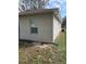 Exterior side of a home showcasing a neutral paint and a window at 424 Crabtree Ave, Orlando, FL 32835