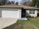 Cozy home with a single car garage, a well maintained lawn, and a flower pot near the entrance at 424 Crabtree Ave, Orlando, FL 32835