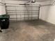 This garage is spacious, with a rolling door and concrete flooring, ready for parking at 424 Crabtree Ave, Orlando, FL 32835