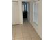 Hallway with tile flooring, a closet, and an open view to the bathroom at 424 Crabtree Ave, Orlando, FL 32835