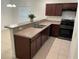 Kitchen featuring stainless steel sink, dark cabinets and matching counters at 424 Crabtree Ave, Orlando, FL 32835