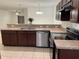 Kitchen featuring stainless steel appliances and dark wood cabinets at 424 Crabtree Ave, Orlando, FL 32835