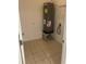 This is a utility room with tile flooring, a hot water tank, and washer-dryer hookups at 424 Crabtree Ave, Orlando, FL 32835