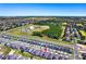 High angle shot showing a housing community with many homes, green trees, and a clear blue sky at 4485 Davos Dr, Clermont, FL 34711