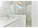 Bright bathroom featuring a stone countertop vanity and a glass enclosed shower at 4485 Davos Dr, Clermont, FL 34711