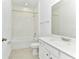 Clean bathroom featuring a bathtub with shower, white tile, and modern vanity at 4485 Davos Dr, Clermont, FL 34711