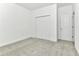 A spacious bedroom with closet, a door to another room, and neutral carpet at 4485 Davos Dr, Clermont, FL 34711