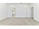 A bedroom with neutral carpet showing an entrance to a bathroom at 4485 Davos Dr, Clermont, FL 34711