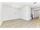 An airy dining room boasts contemporary light fixture and light-colored wood floors at 4485 Davos Dr, Clermont, FL 34711