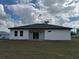 The house has a backyard with large windows and sliding glass doors at 4875 Sw 159Th Lane Rd, Ocala, FL 34473