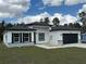 A charming home showcases a dark-colored roof, garage door, and black shutters at 4875 Sw 159Th Lane Rd, Ocala, FL 34473