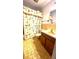 Bathroom featuring gold tile, vanity, toilet, and shower with patterned curtain at 5339 Cypress Dr, Winter Park, FL 32792