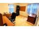 Bedroom featuring tan carpet, a desk, a board, and windows with blue curtains at 5339 Cypress Dr, Winter Park, FL 32792