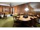 Dining room featuring wood paneling, a ceiling fan, and carpet at 5339 Cypress Dr, Winter Park, FL 32792